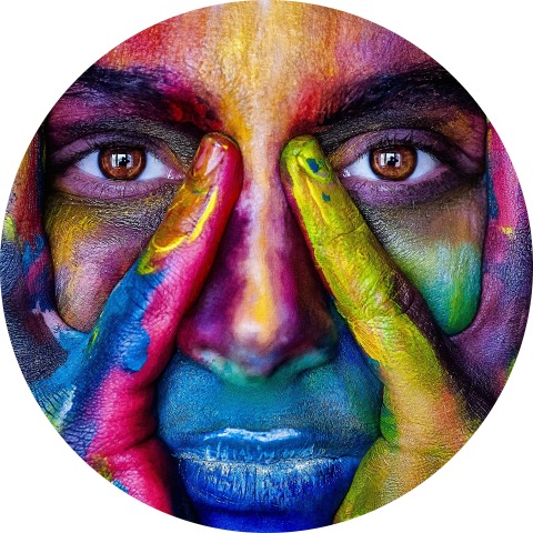 Multi-coloured painted face symbolising women’s creativity